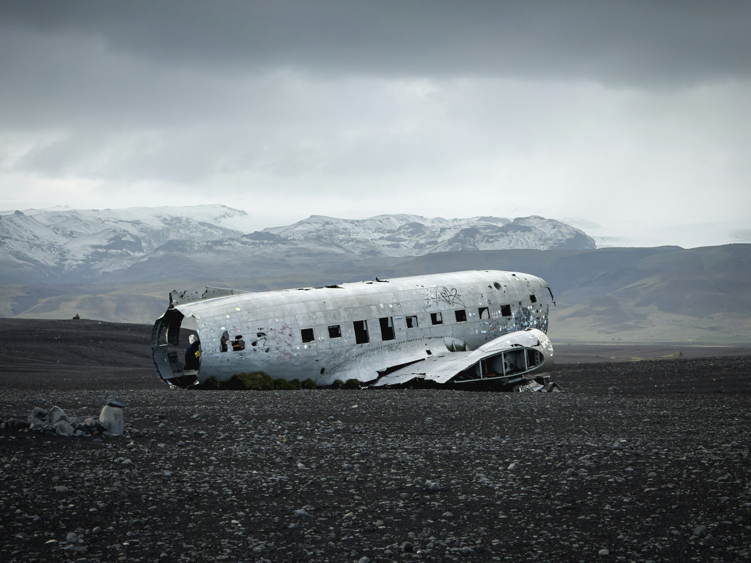 Abandoned aircraft wreck on desolate terrain representing the unanswered questions surrounding the MU5735 investigation and four years of CAAC silence