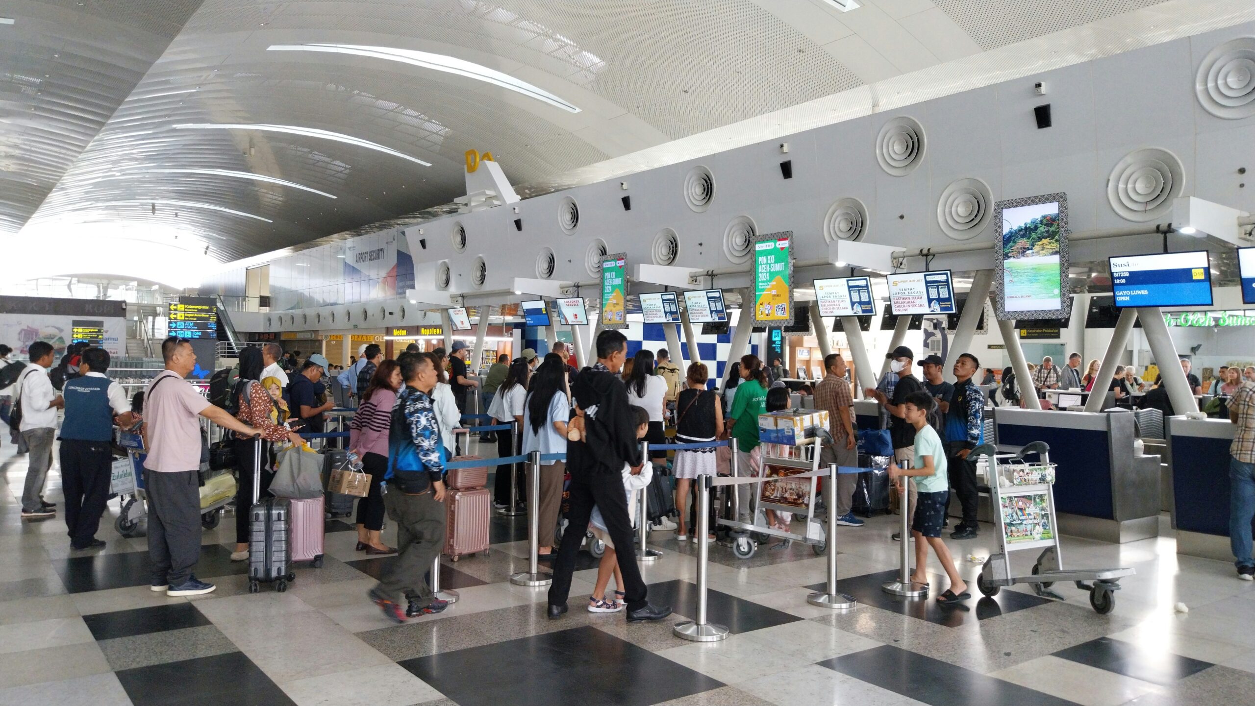 Passengers queuing at airline check-in counters at international airport